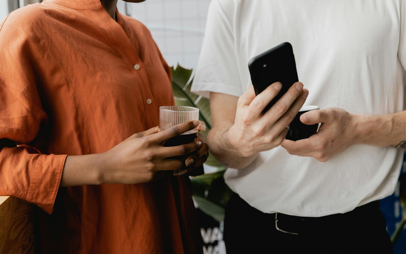 Two people looks at a phone